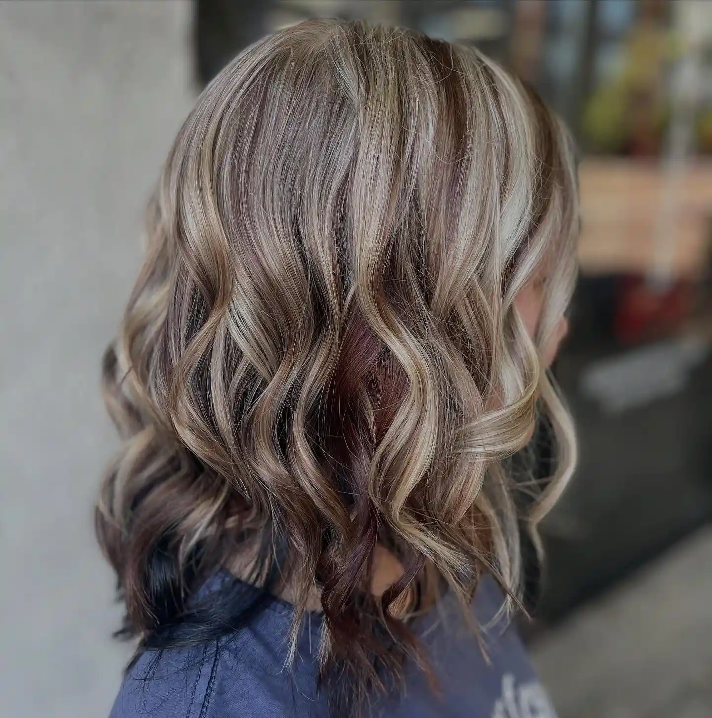 Shoulder Length Blonde Waves with Deep Burgundy Underlights