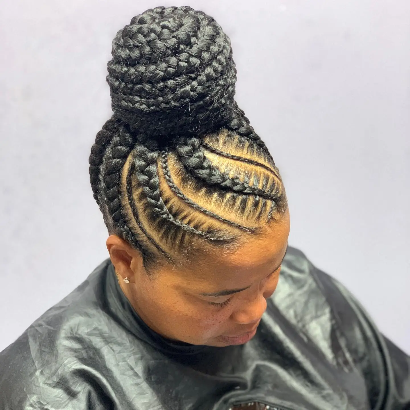 Braided High Bun with Intricate Cornrow Patterns