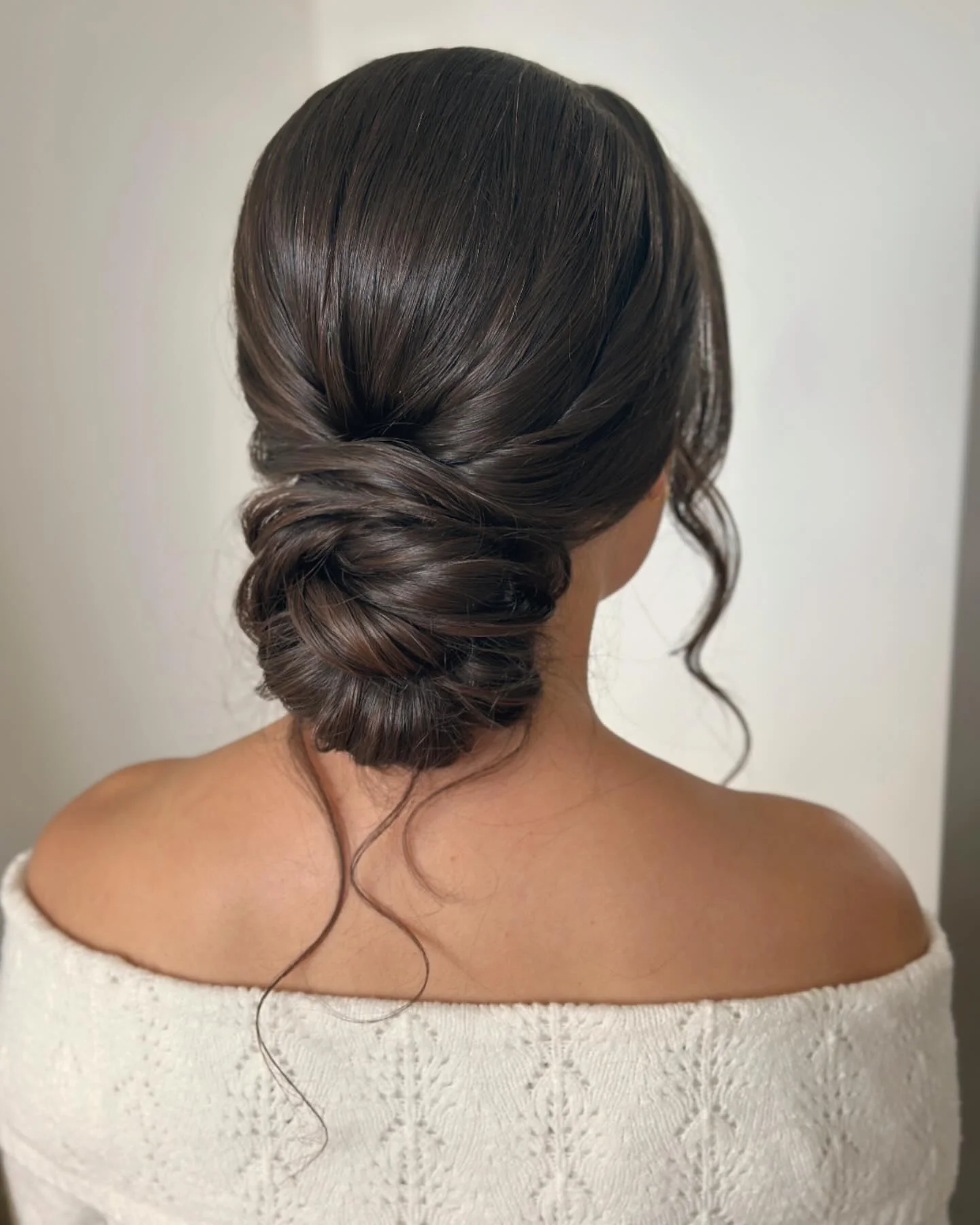 Twisted Low Bun with Soft Loose Face Framing Strands