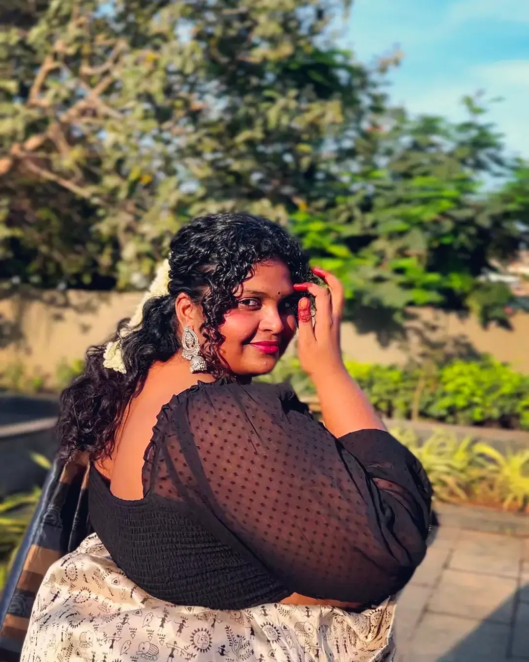 Half-Up Curly Hairstyle with Soft Face-Framing Pieces