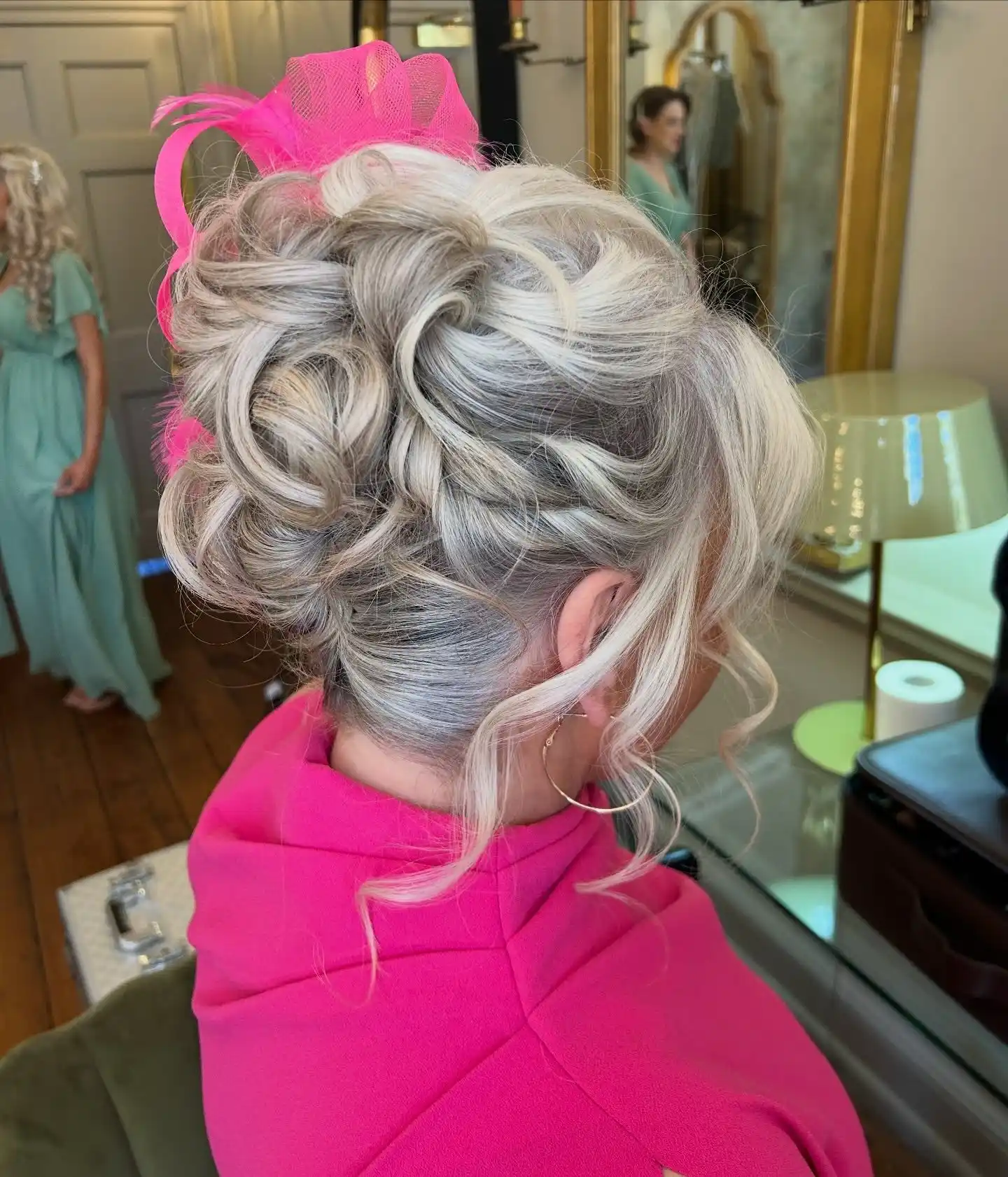 Textured High Bun with Face Framing Tendrils