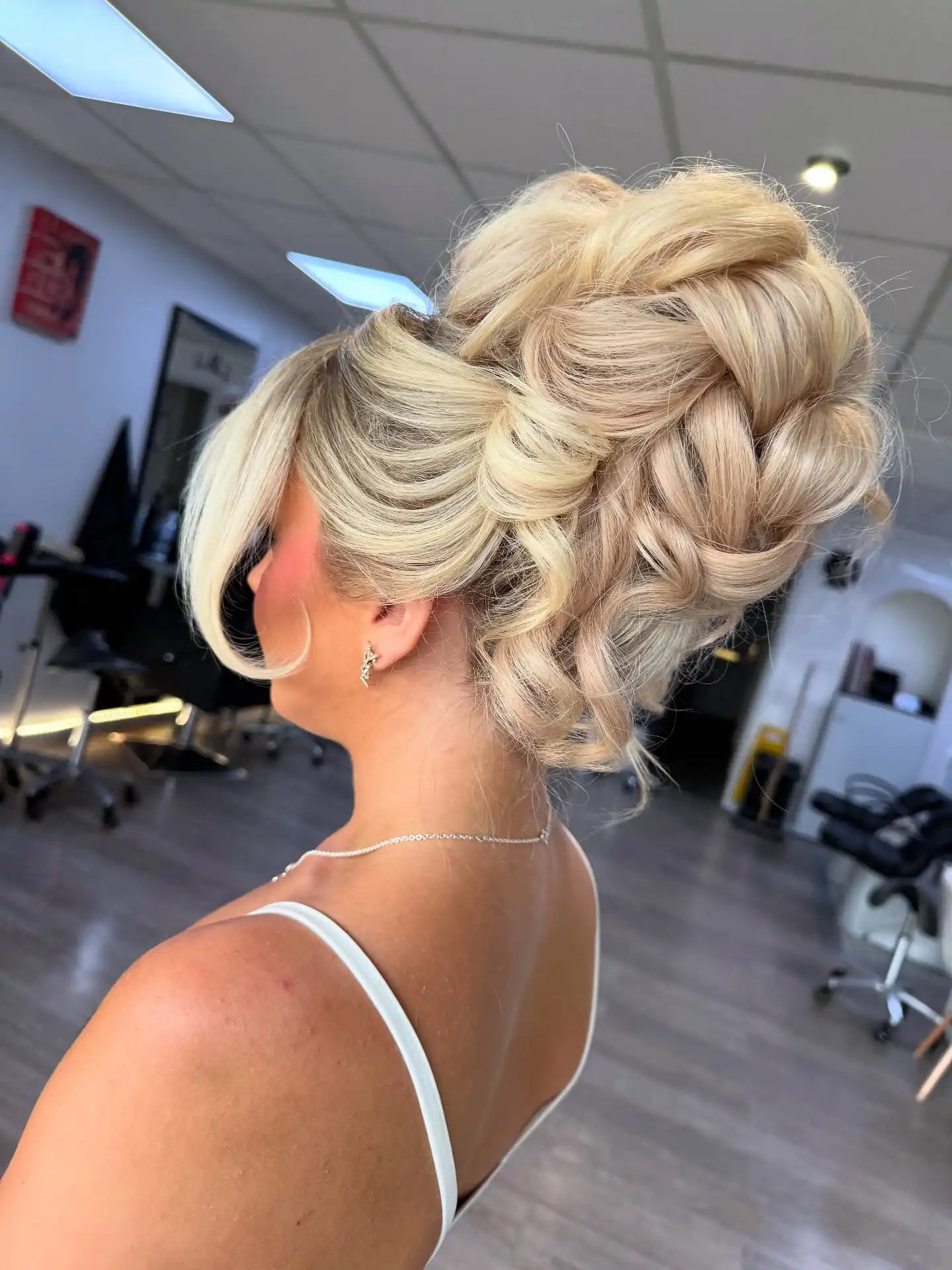Voluminous Blonde Chignon with Soft Curled Pieces
