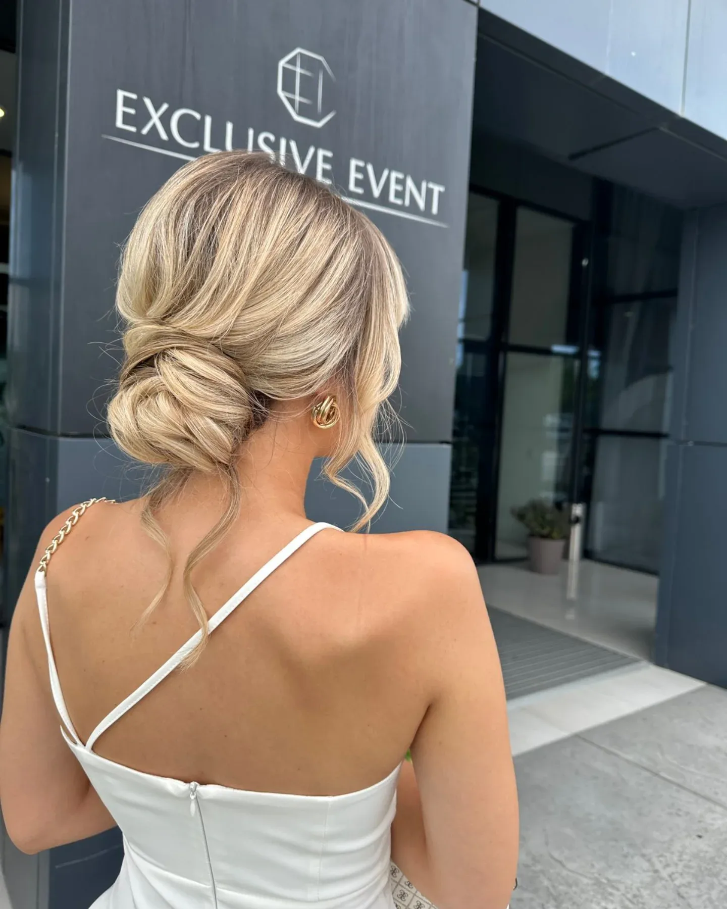 Low Textured Blonde Chignon with Soft Face-Framing Pieces