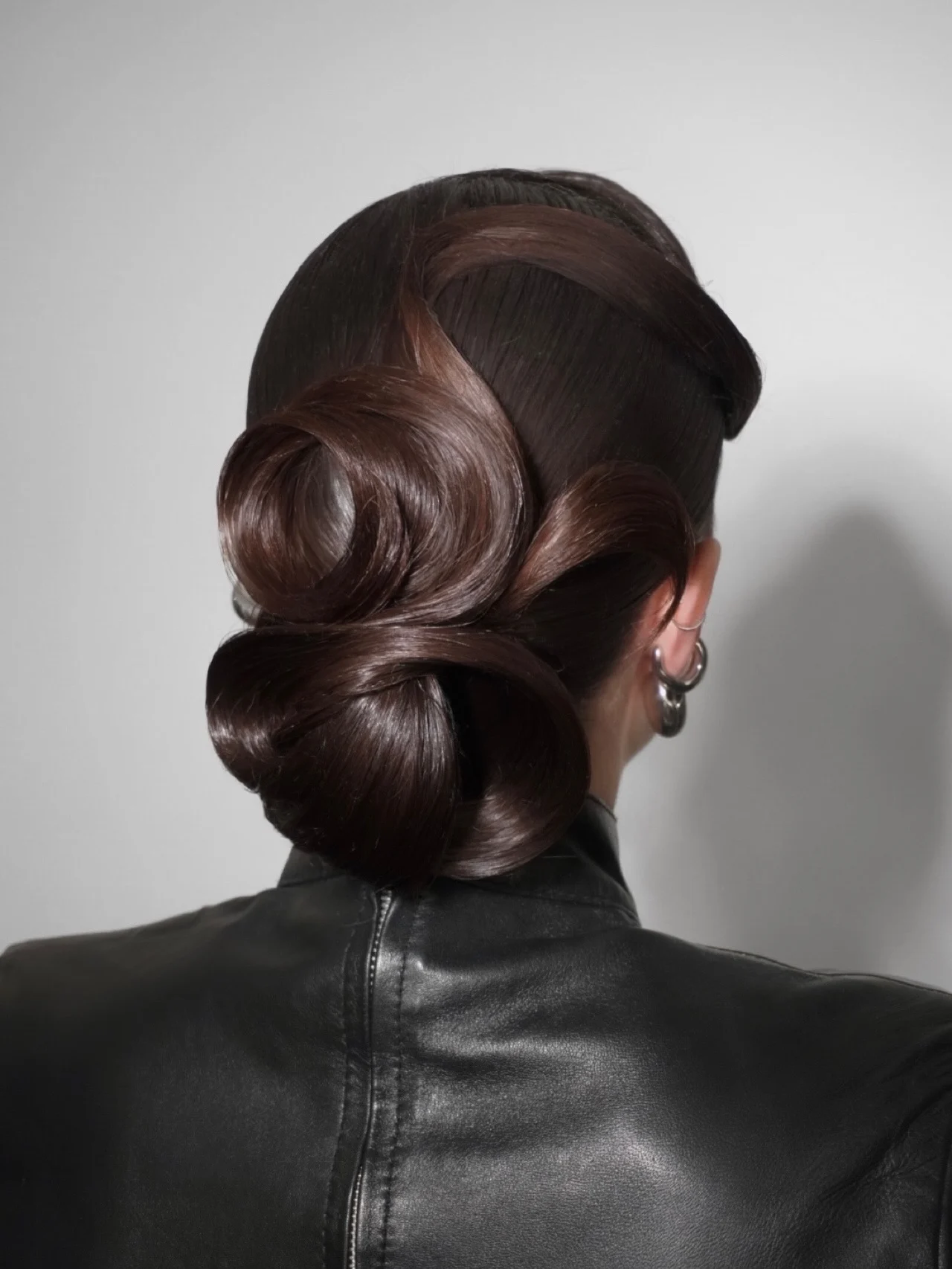  Sculptural Twisted Low Bun with Glossy Waves