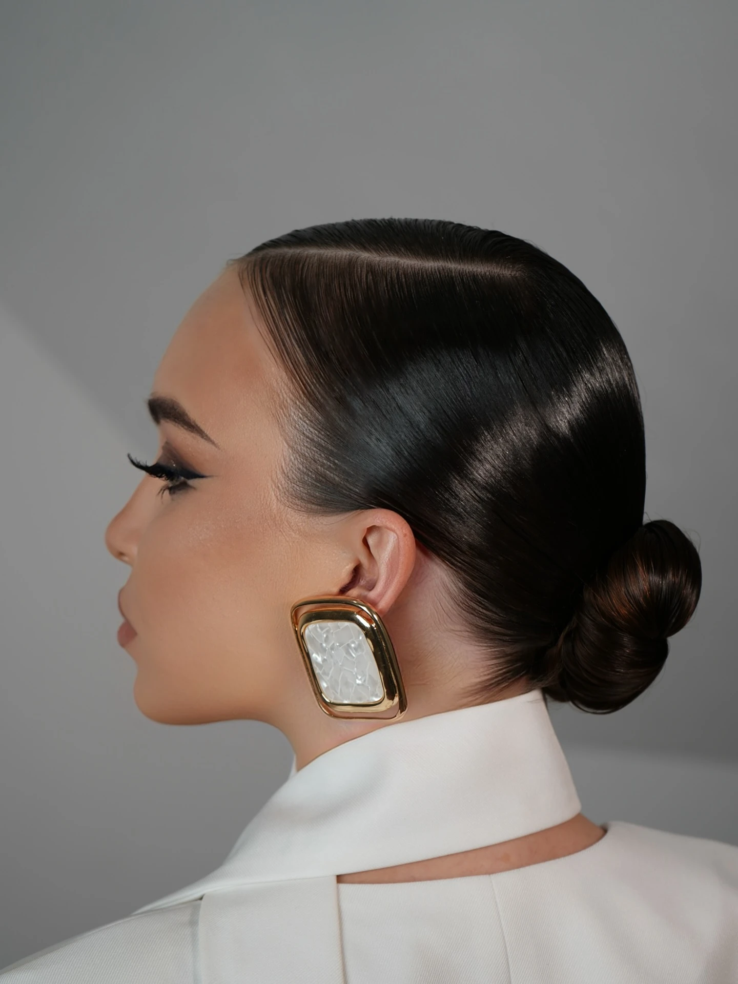 Sleek Low Chignon with Glossy Side Part